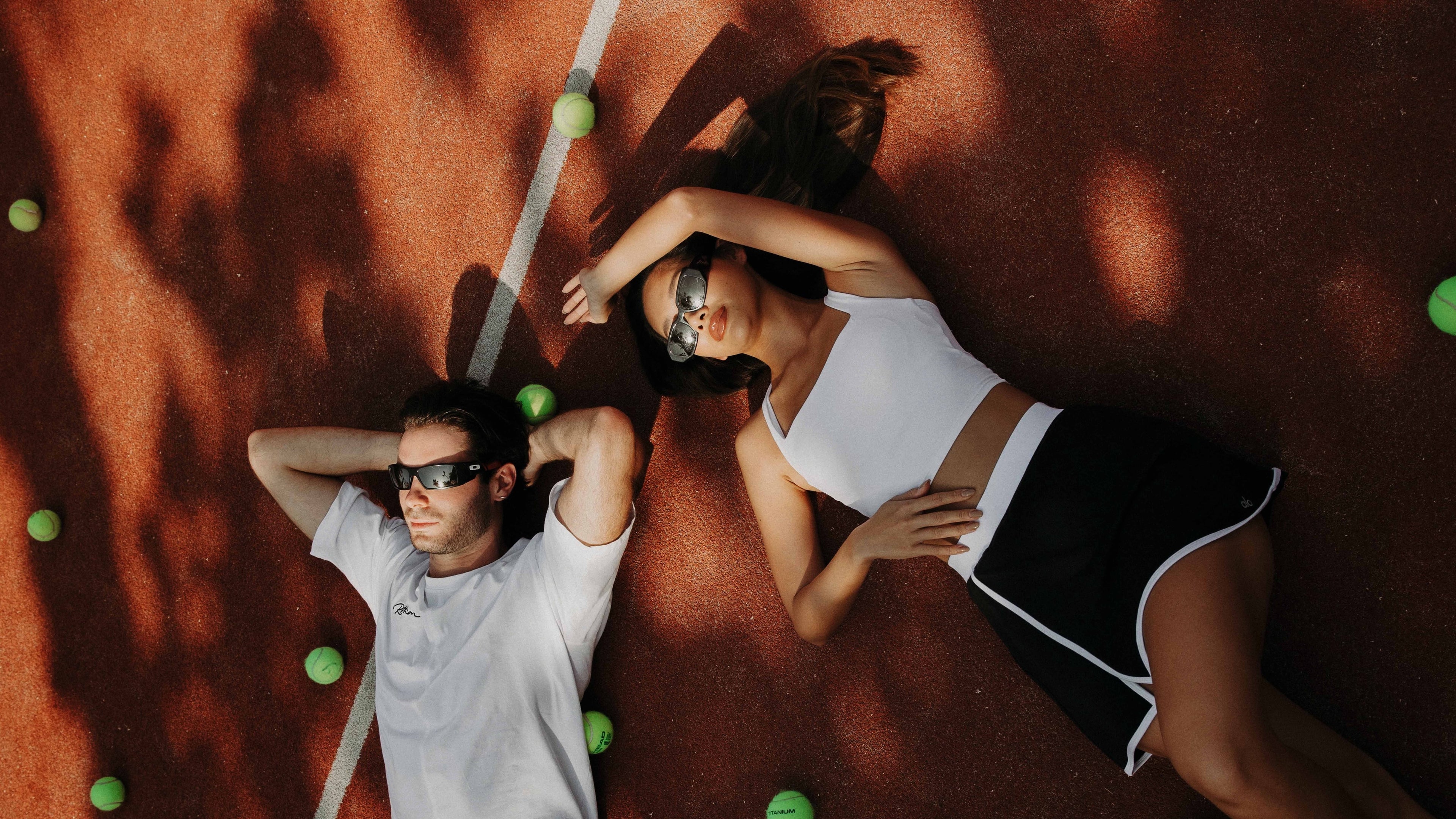 Two people lying on a textured surface 